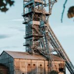 Rusty industrial mining tower in Heusden-Zolder, Belgium during daylight.